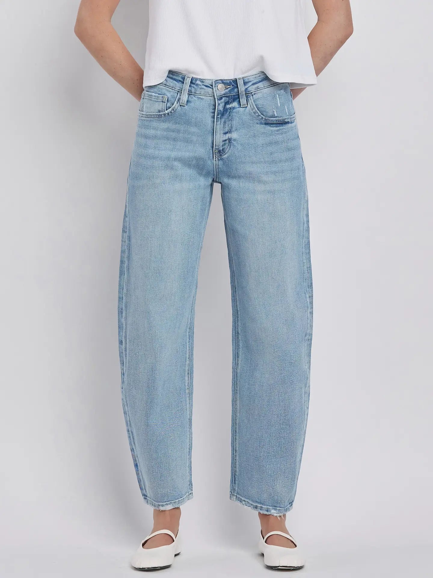 Women's light wash high-rise barrel leg jeans featuring a relaxed curved silhouette, subtle distressing, and an ankle-length hem.