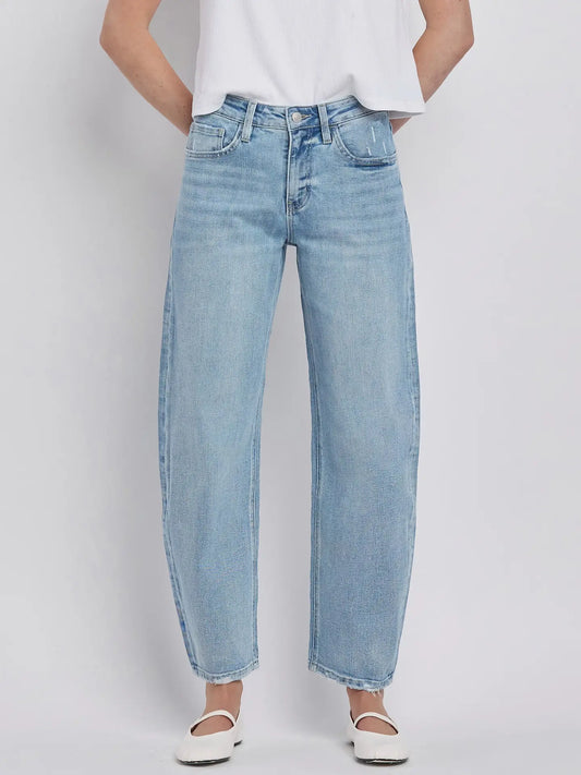 Women's light wash high-rise barrel leg jeans featuring a relaxed curved silhouette, subtle distressing, and an ankle-length hem.