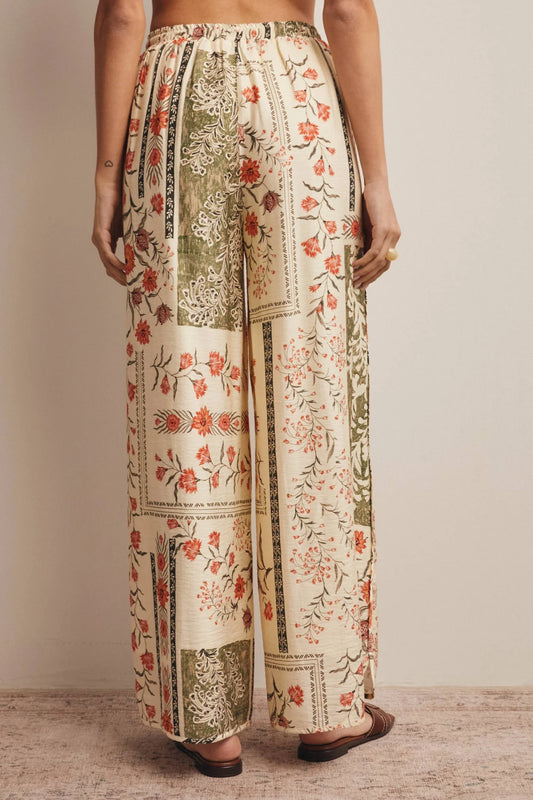 High-waisted wide-leg patchwork floral print pants in ecru, terracotta, and olive green featuring a comfortable elastic drawstring waistband and a relaxed silhouette.