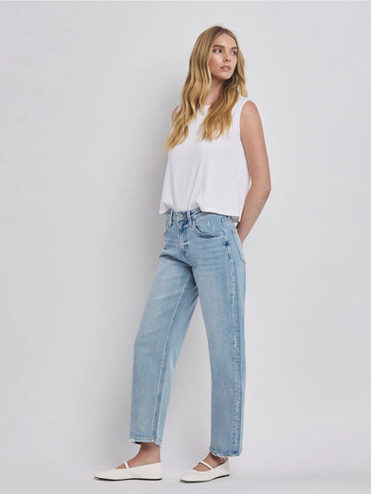 Women's light wash high-rise barrel leg jeans featuring a relaxed curved silhouette, subtle distressing, and an ankle-length hem.