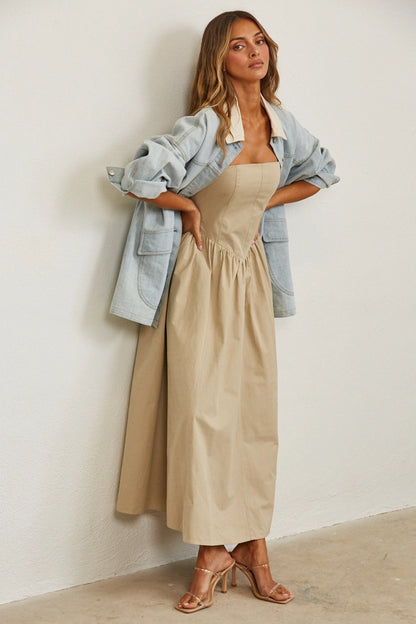 A women's relaxed oversized light wash denim utility jacket featuring a cream-colored pointed contrast collar, a button-front closure, and large front patch pockets with flaps.