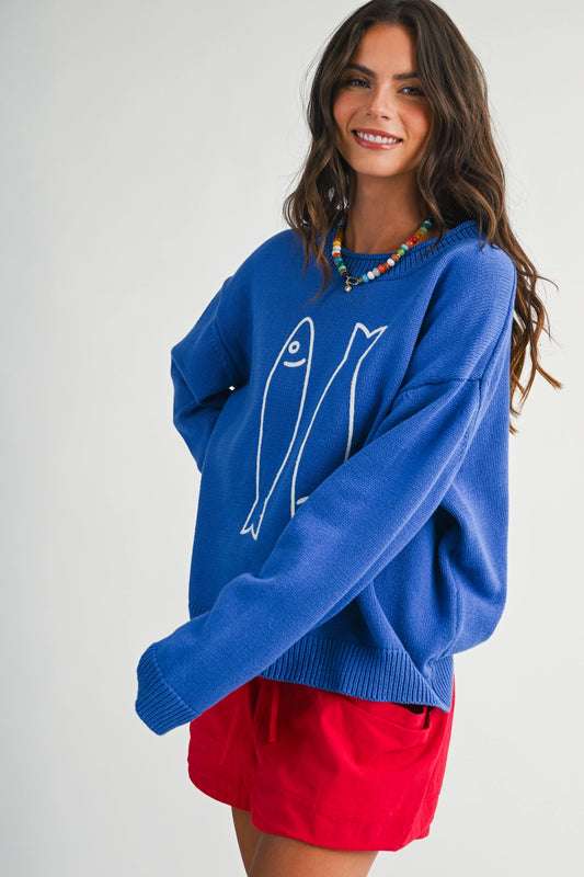 A women's royal blue long-sleeve knit crewneck sweater featuring a white embroidered sardine graphic on the front and ribbed trim along the collar, cuffs, and hem.