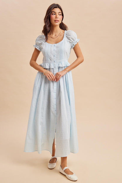 Maxi Dress in airy blue is a lightweight, feminine yellow maxi dress featuring delicate Swiss dot fabric, puff sleeves, and a flattering button-front bodice. 