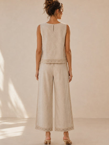 A women's two-piece linen-blend clothing set in an oat color featuring a sleeveless top with a chest diamond crochet applique and matching high-waisted wide-leg pants with lace trim panels along the sides and hems.