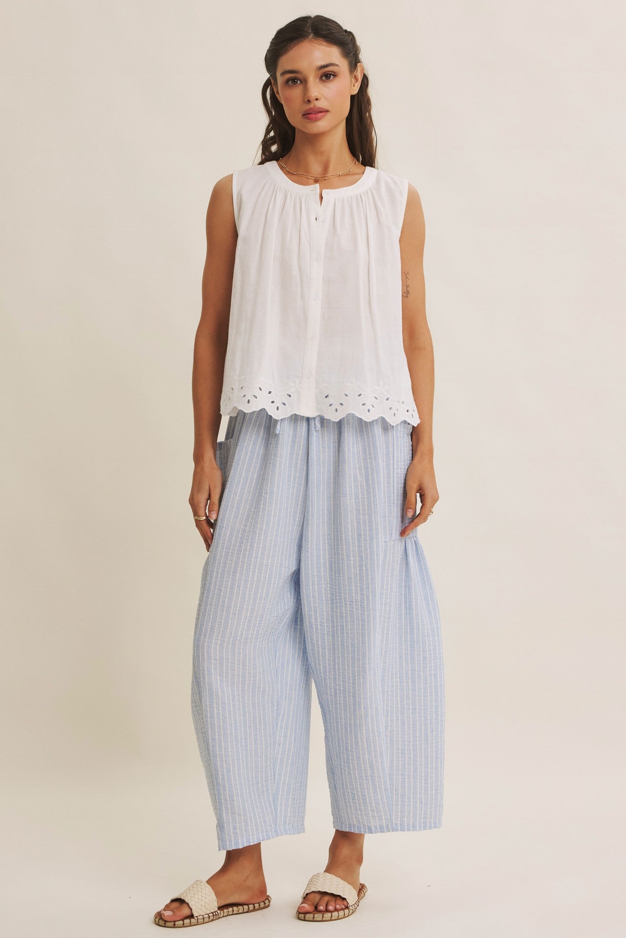 Striped Pants offer a relaxed fit, an elastic waistband with adjustable drawstring with voluminous legs and dropped side pockets in light blue. 