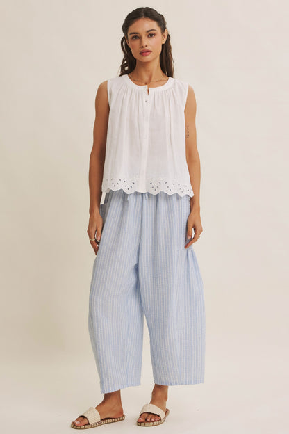 Striped Pants offer a relaxed fit, an elastic waistband with adjustable drawstring with voluminous legs and dropped side pockets in light blue. 