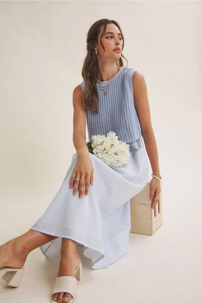 A women's sky blue mixed media midi dress featuring a sleeveless open-knit sweater vest top and an attached gathered striped midi skirt.