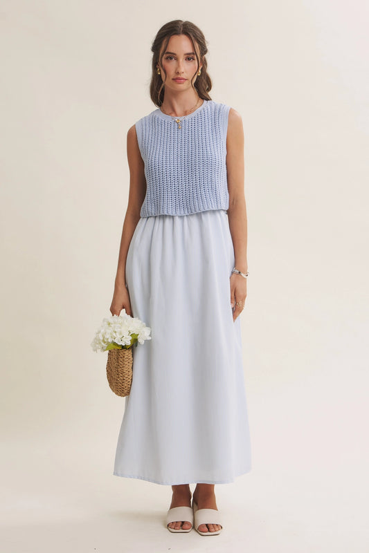 A women's sky blue mixed media midi dress featuring a sleeveless open-knit sweater vest top and an attached gathered striped midi skirt.