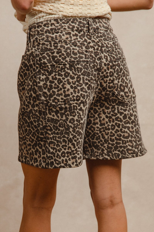 Leopard print denim shorts with button and zipper closure, and front and back pockets. 