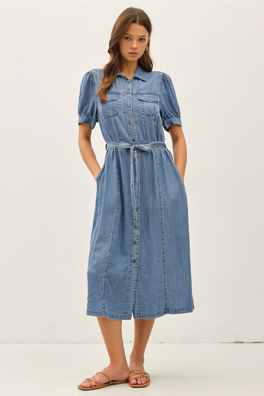 A women's short puff-sleeve denim shirt dress in a light wash featuring a pointed collar, a full button-down front, a matching waist tie belt, and convenient side pockets.