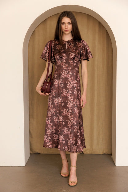 A women's dusty mauve floral print midi dress featuring short flutter sleeves, a structured smocked bodice, and an A-line skirt