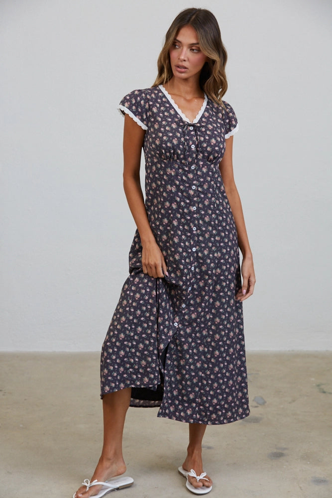 A women's short flutter sleeve midi dress in antique black featuring a pink vintage rose floral print, white scalloped lace trim along the V-neckline, and a full button-down front.