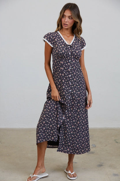 A women's short flutter sleeve midi dress in antique black featuring a pink vintage rose floral print, white scalloped lace trim along the V-neckline, and a full button-down front.