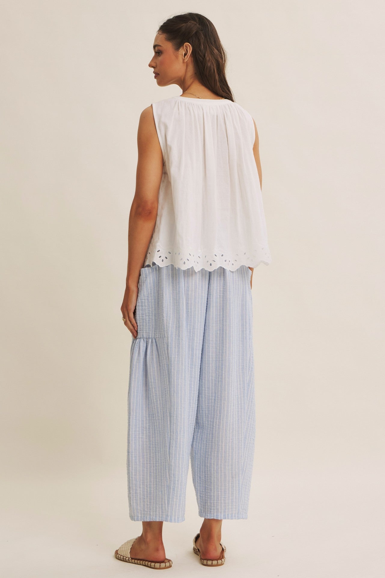 Striped Pants offer a relaxed fit, an elastic waistband with adjustable drawstring with voluminous legs and dropped side pockets in light blue. 