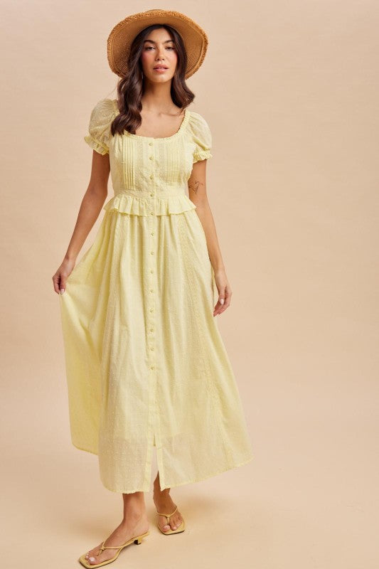 Maxi Dress in Lemon Water Yellow is a lightweight, feminine yellow maxi dress featuring delicate Swiss dot fabric, puff sleeves, and a flattering button-front bodice.