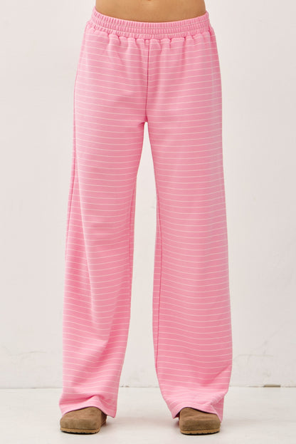 Women's flowy wide-leg lounge pants in bubblegum pink and ivory micro-stripes featuring a flat elastic waistband and relaxed silhouette.