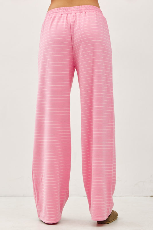 Women's flowy wide-leg lounge pants in bubblegum pink and ivory micro-stripes featuring a flat elastic waistband and relaxed silhouette.