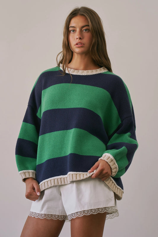 A women's heavy-knit oversized pullover sweater featuring emerald green and navy horizontal stripes with oatmeal cream ribbed crew neckline, cuffs, and hem.