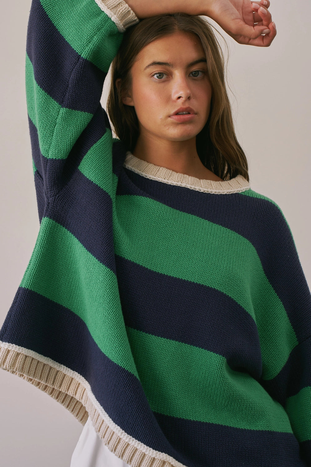 A women's heavy-knit oversized pullover sweater featuring emerald green and navy horizontal stripes with oatmeal cream ribbed crew neckline, cuffs, and hem.