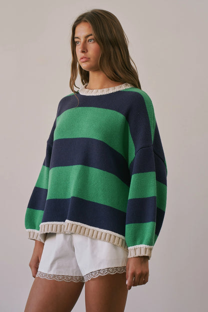 A women's heavy-knit oversized pullover sweater featuring emerald green and navy horizontal stripes with oatmeal cream ribbed crew neckline, cuffs, and hem.