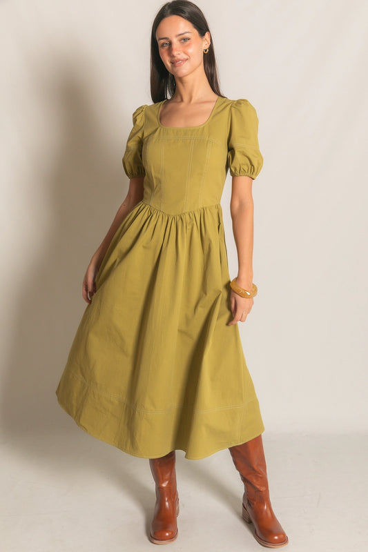 A martini green cotton twill midi dress featuring a square neckline, short puff sleeves, and defined white contrast stitching throughout the structured bodice and hem.