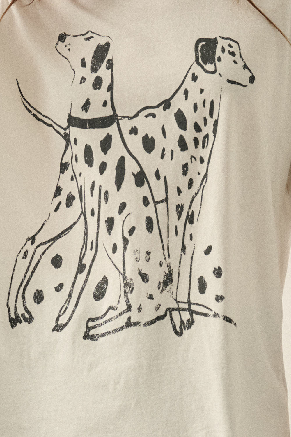An ivory graphic tee featuring a black Dalmatian dog design, a soft crew neckline, and a relaxed, comfortable fit for everyday wear.