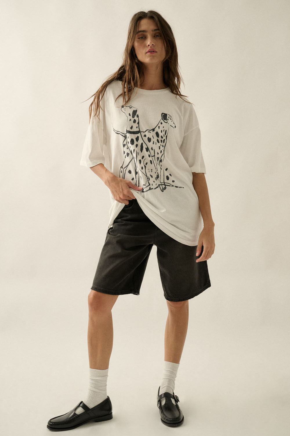 An ivory graphic tee featuring a black Dalmatian dog design, a soft crew neckline, and a relaxed, comfortable fit for everyday wear.