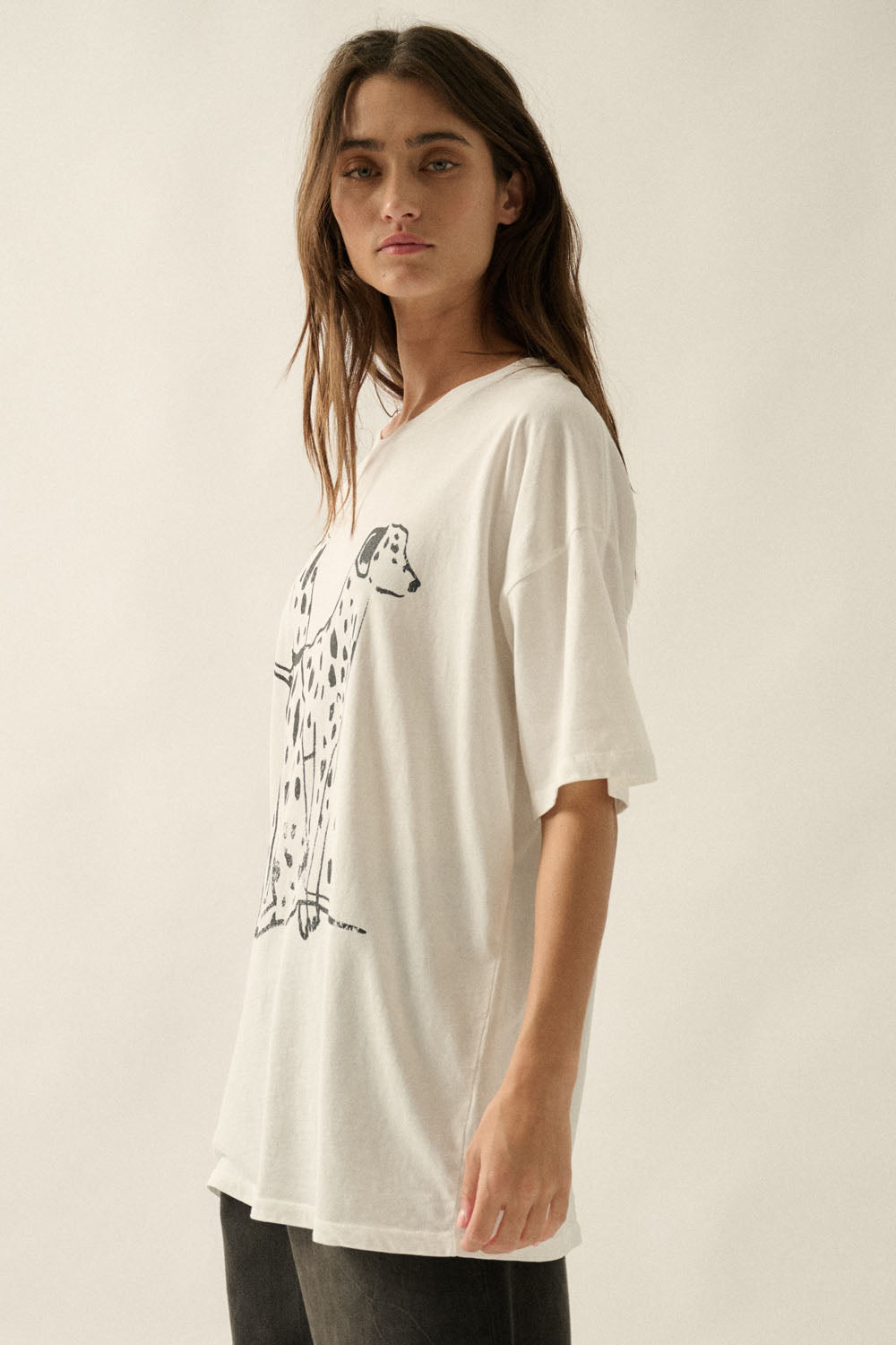 An ivory graphic tee featuring a black Dalmatian dog design, a soft crew neckline, and a relaxed, comfortable fit for everyday wear.