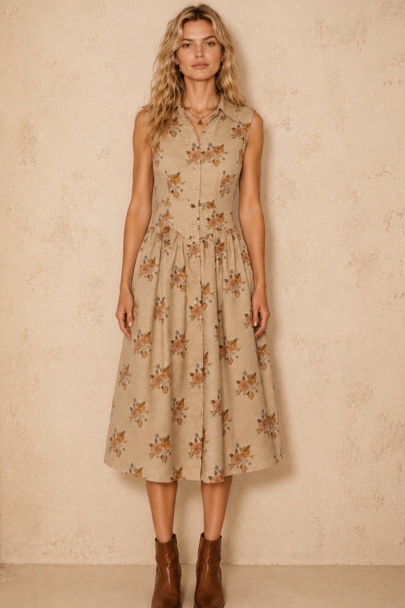 A women's sleeveless cream midi dress featuring a warm floral print, a collared neckline, front button closures, a gathered waistline, and functional side pockets.
