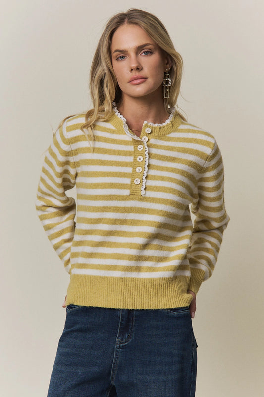 A women's long-sleeve knit henley sweater in mustard yellow and cream horizontal stripes featuring a white eyelet lace trim along the neckline and button placket.