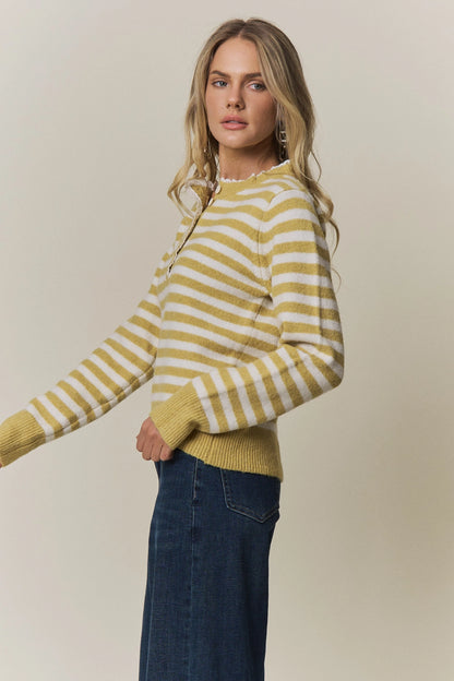 A women's long-sleeve knit henley sweater in mustard yellow and cream horizontal stripes featuring a white eyelet lace trim along the neckline and button placket.