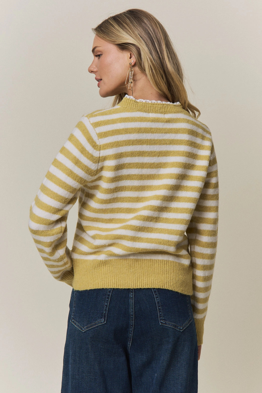 A women's long-sleeve knit henley sweater in mustard yellow and cream horizontal stripes featuring a white eyelet lace trim along the neckline and button placket.