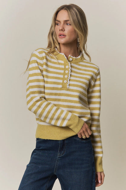 A women's long-sleeve knit henley sweater in mustard yellow and cream horizontal stripes featuring a white eyelet lace trim along the neckline and button placket.
