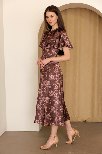A women's dusty mauve floral print midi dress featuring short flutter sleeves, a structured smocked bodice, and an A-line skirt