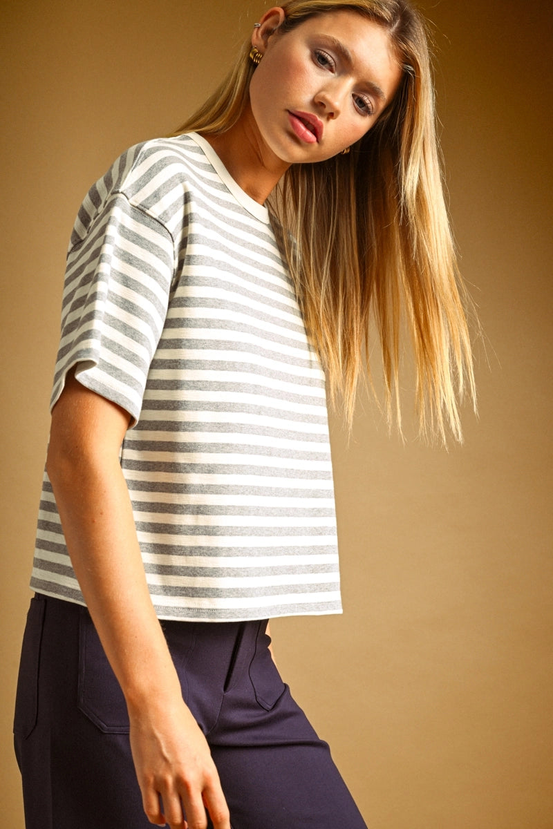 A women's crewneck short-sleeve tee featuring a light heather gray and white horizontal stripe design in a soft, relaxed fit.