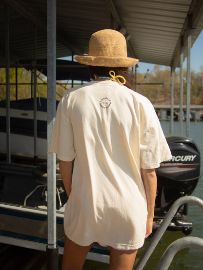 A women's oversized relaxed-fit cream graphic t-shirt featuring three stacked fish illustrations in shades of coral, pink, and red with the phrase "What A Catch" printed in the bottom right corner.