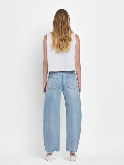 Women's light wash high-rise barrel leg jeans featuring a relaxed curved silhouette, subtle distressing, and an ankle-length hem.