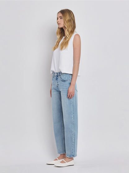 Women's light wash high-rise barrel leg jeans featuring a relaxed curved silhouette, subtle distressing, and an ankle-length hem.