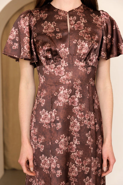 A women's dusty mauve floral print midi dress featuring short flutter sleeves, a structured smocked bodice, and an A-line skirt