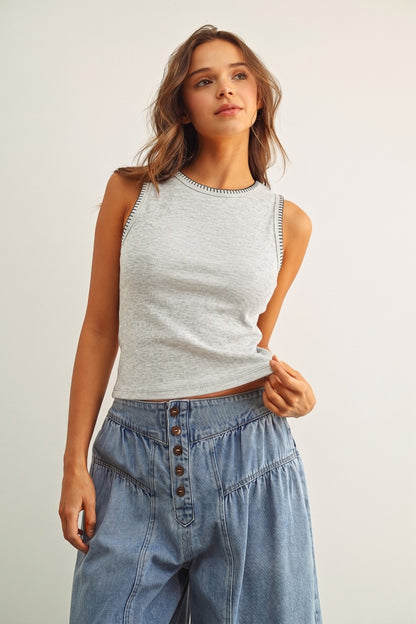 A women's sleeveless crewneck ribbed knit tank top in heather gray featuring a contrasting black blanket-stitch detail along the neckline and armholes.