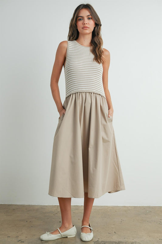 Striped sleeveless dress in taupe and ivory. Contains a solid flowy cotton bottom with a striped smocked top. 