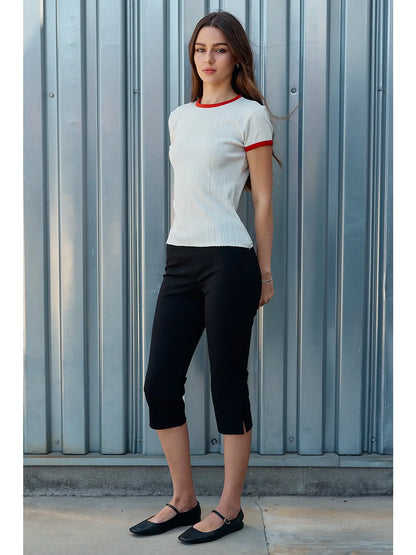 A women's ivory pointelle knit crewneck ringer t-shirt featuring bright red contrast trim along the neckline and sleeves, short sleeves, and a textured vertical diamond stitch pattern.