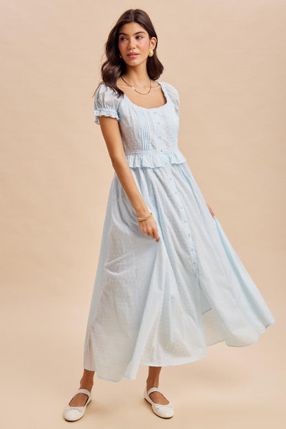 Maxi Dress in airy blue is a lightweight, feminine yellow maxi dress featuring delicate Swiss dot fabric, puff sleeves, and a flattering button-front bodice. 