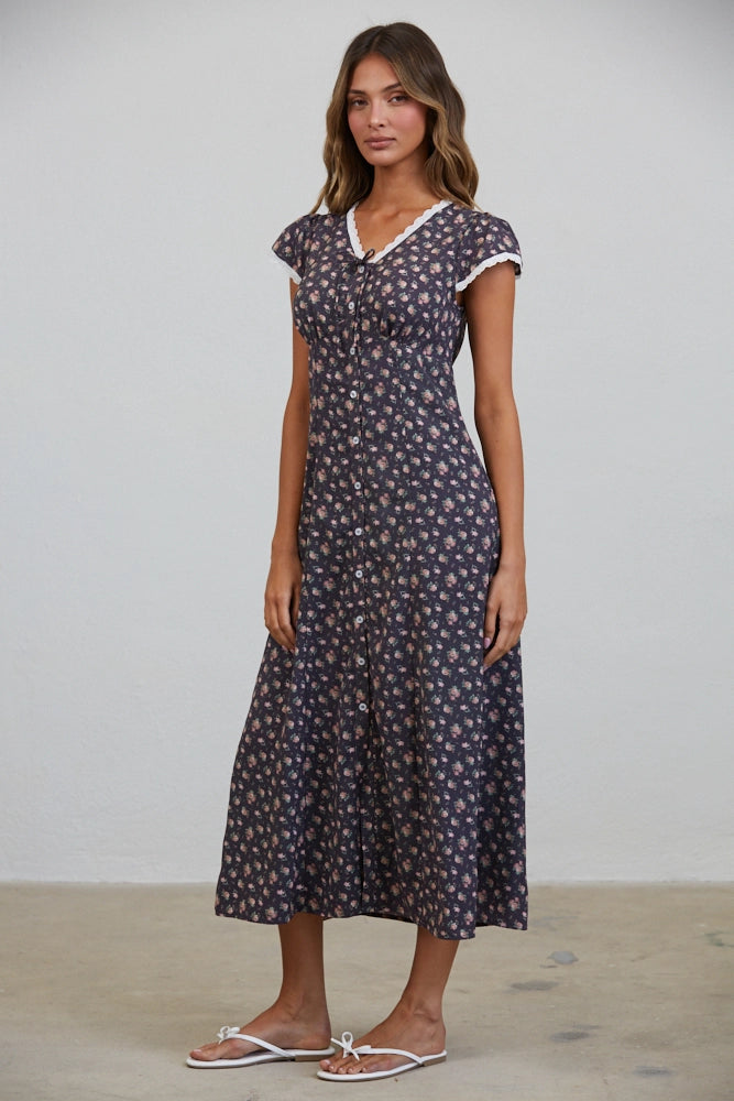 A women's short flutter sleeve midi dress in antique black featuring a pink vintage rose floral print, white scalloped lace trim along the V-neckline, and a full button-down front.