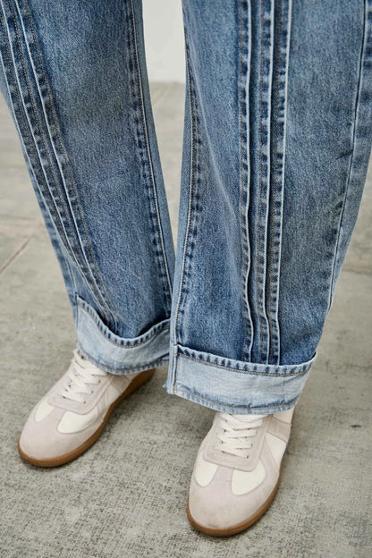 Medium wash barrel denim jeans. 
Button and zipper closure 
Front pleated details
False front cuff detail