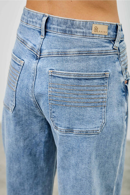 Medium wash barrel denim jeans. 
Button and zipper closure 
Front pleated details
False front cuff
Back pockets 