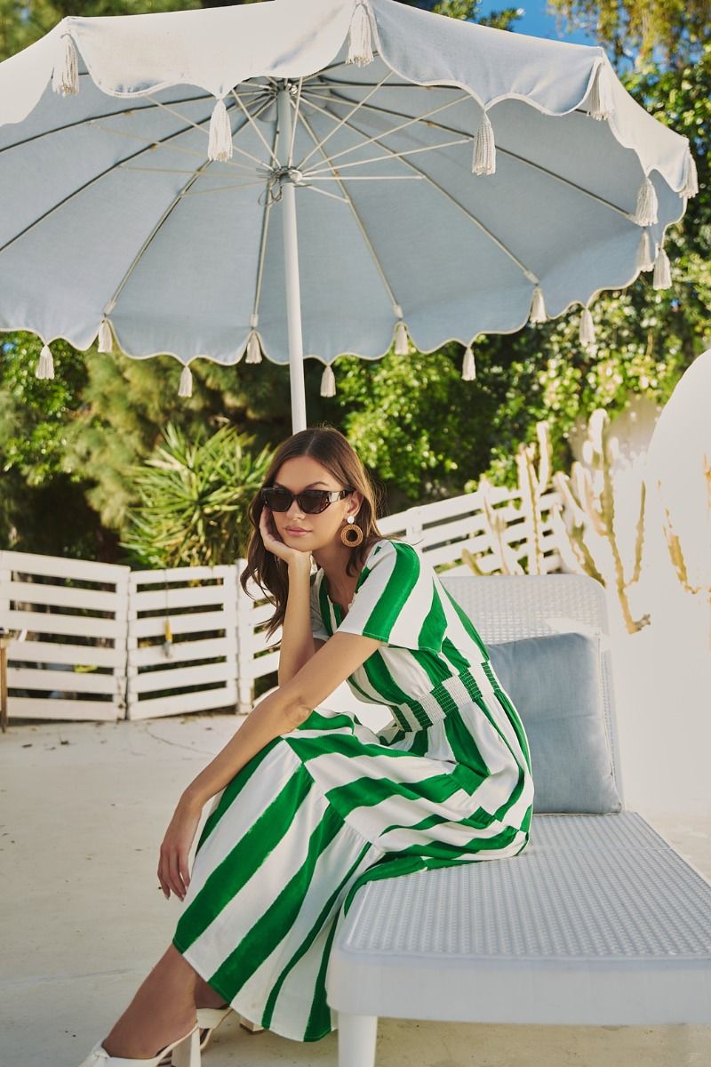 Green and white striped maxi dress with a smocked waist, pockets, and a tiered skirt.   Comes lined with a v-neck. 