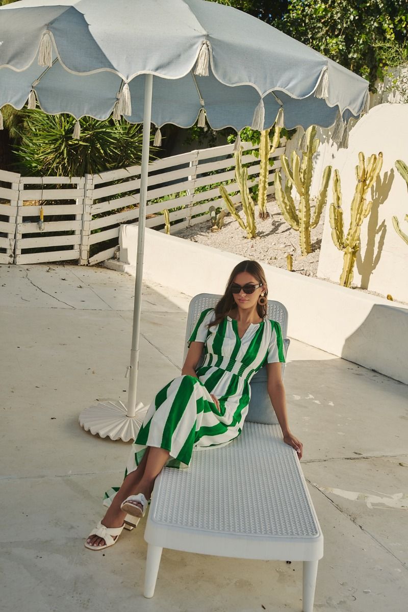 Green and white striped maxi dress with a smocked waist, pockets, and a tiered skirt.   Comes lined with a v-neck. 