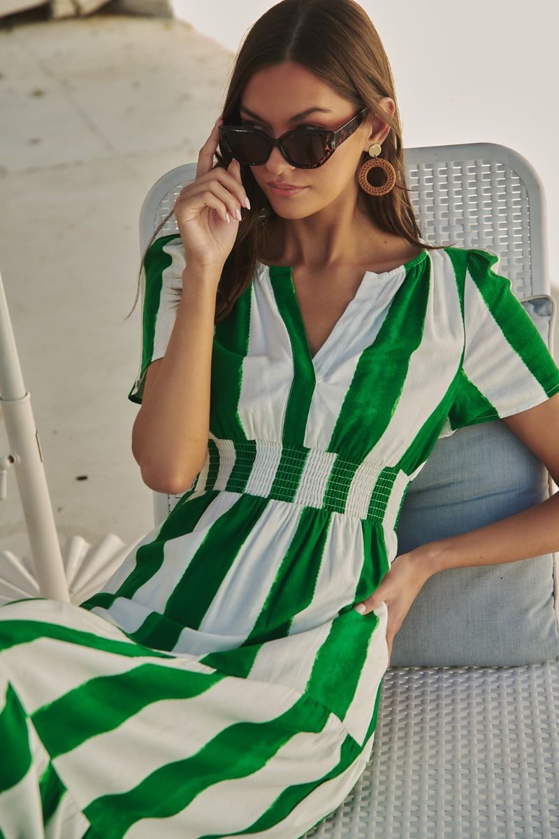 Green and white striped maxi dress with a smocked waist, pockets, and a tiered skirt.   Comes lined with a v-neck. 