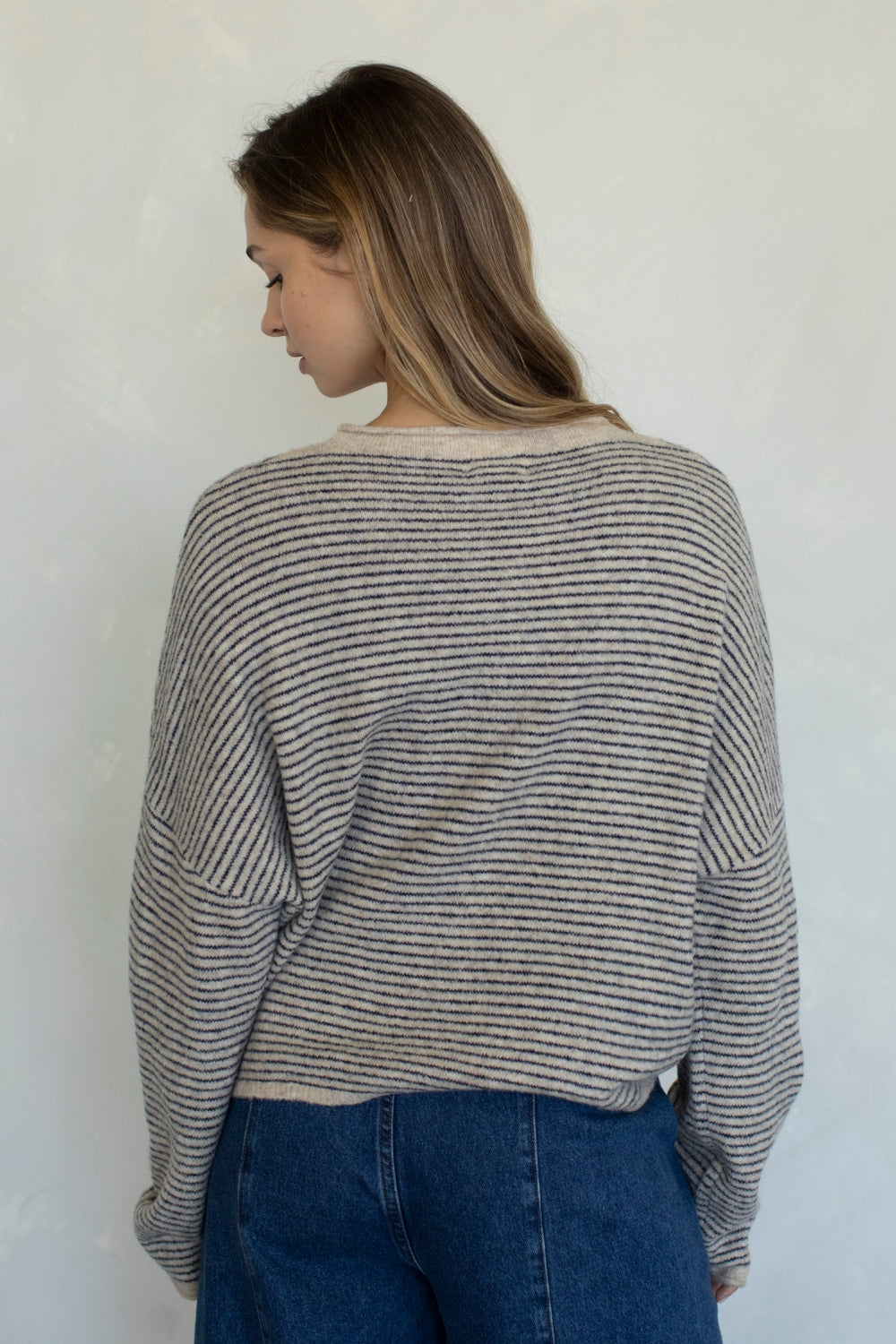 Lightweight, rolled neck cardigan in a pin-stripe style.
Button Front 
Natural color 